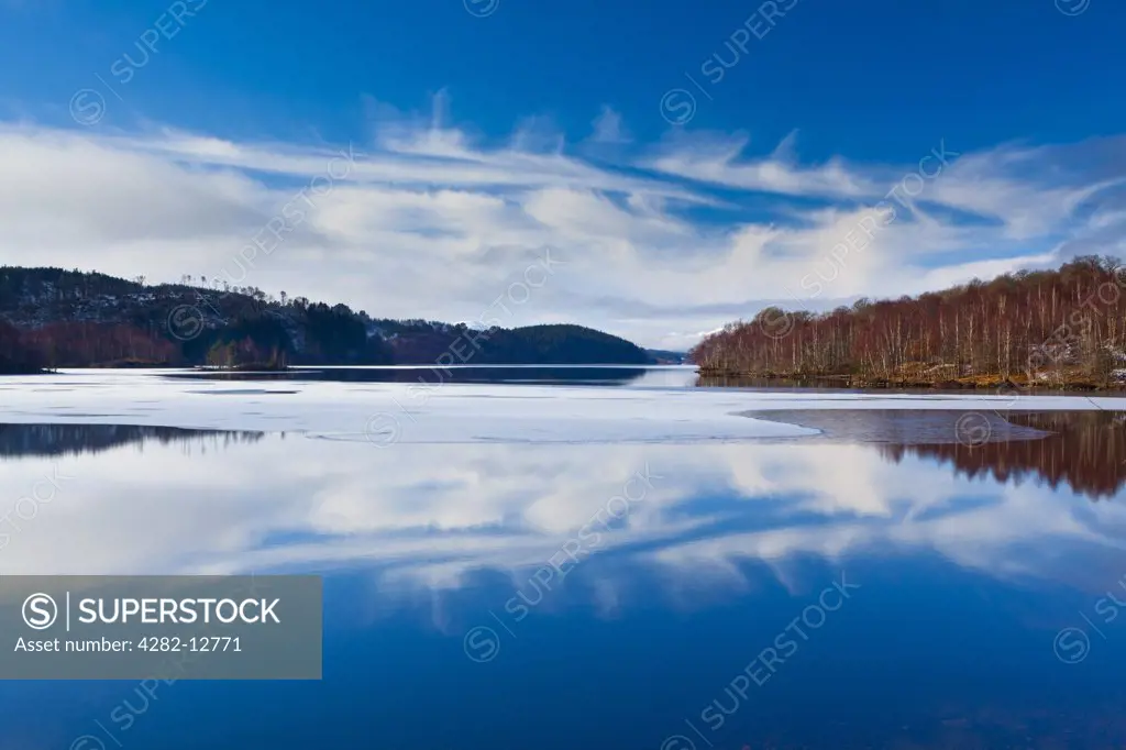 Scotland, Highland, Loch Garry. Cloud formations reflected upon the mirror like face of Loch Garry.