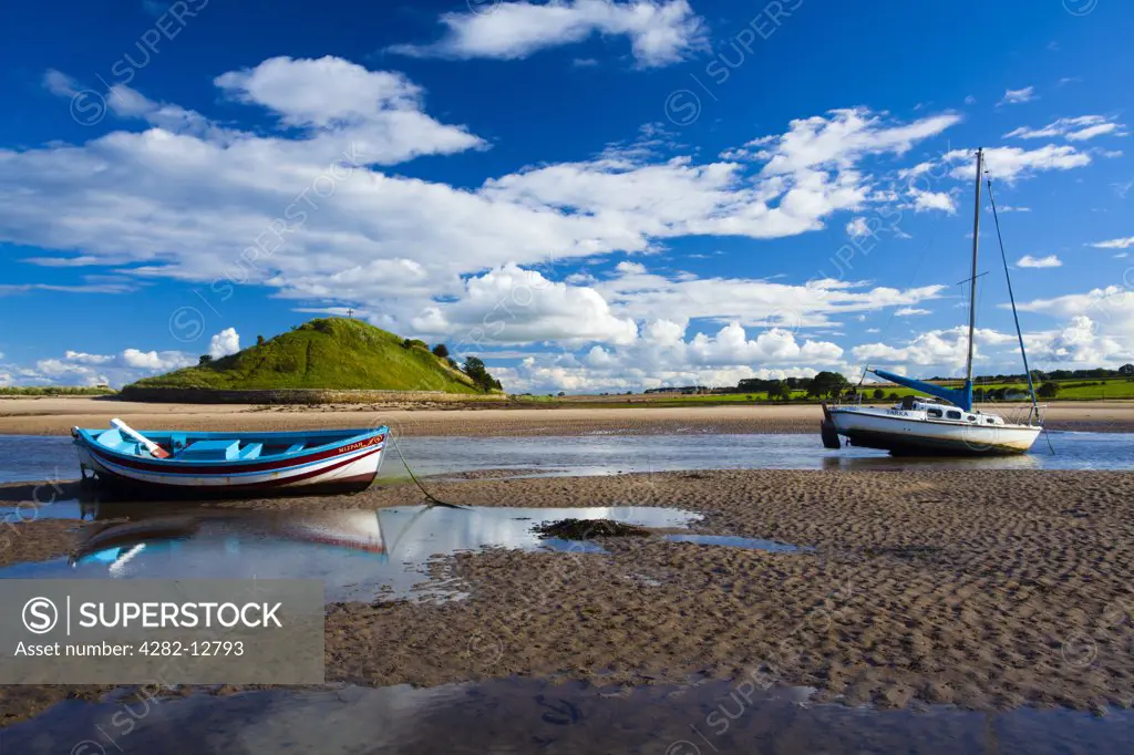 England, Northumberland, Alnmouth. Boats on the tidal Aln Estuary at Alnmouth. The hill in the distance is known as Church Hill.