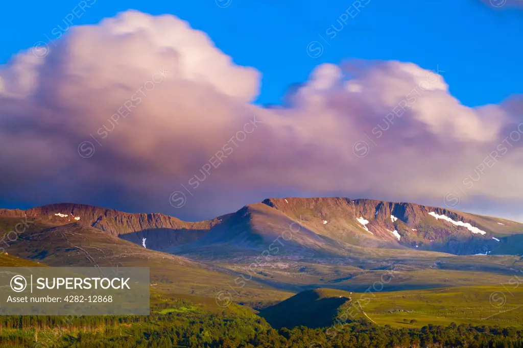 Scotland, Highland, Cairngorms National Park. Late evening light on fast moving clouds above the Cairngorms massif in the Cairngorms National Park.