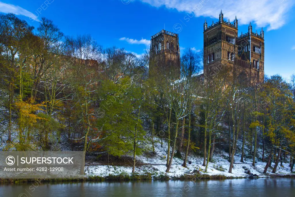 England, County Durham, Durham. Durham Cathedral, situated above the snow covered river banks of the River Wear.