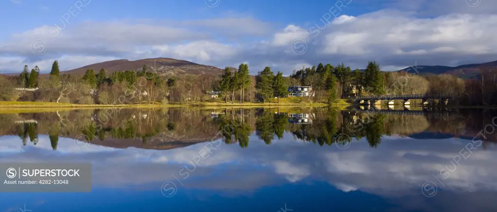 Scotland, Highland, Loch Insh. Mirror like reflections upon Loch Insh near Kincraig in the Cairngorms National Park.