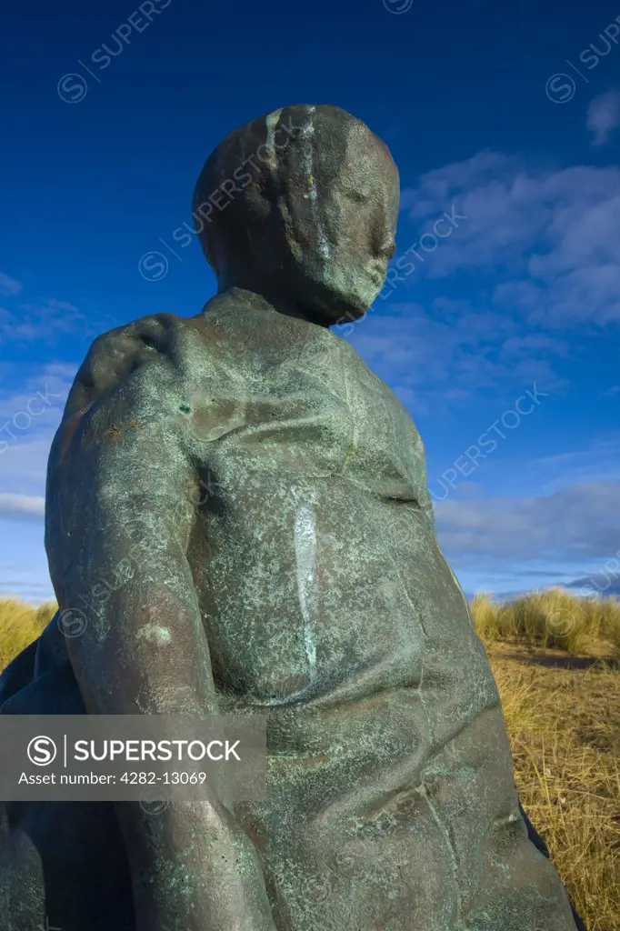 England, Tyne and Wear, South Shields. One of the 22 copper-bronze statues forming the ""Conversation Piece"" artwork near The Groyne lighthouse at Littlehaven Beach, South Shields.