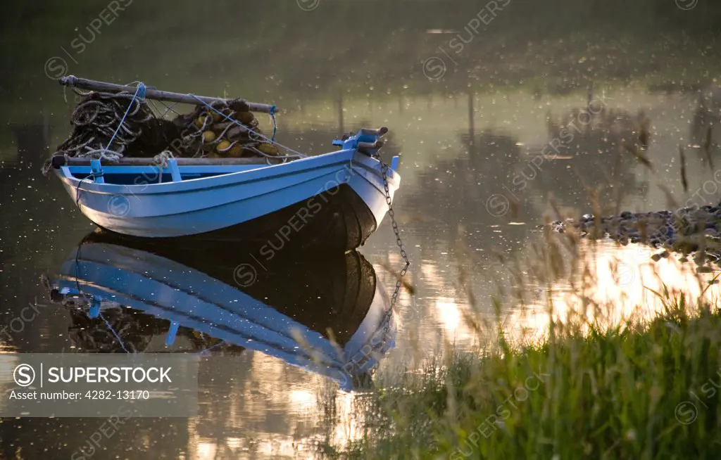 England, Northumberland, Norham. A small fishing boat at Canny fishery by Norham Boathouse.