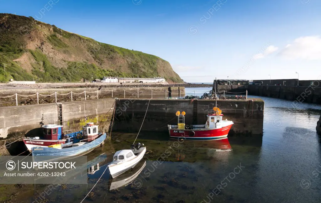 Scotland, Scottish Borders, Burnmouth. Boats in the small fishing harbour at Burnmouth, the first village in Scotland on the A1 after crossing the border with England.