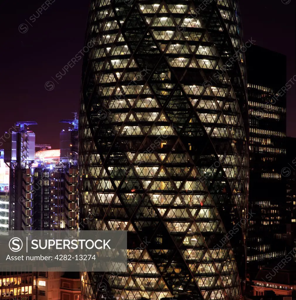 England, London, The City. The Gherkin building in London at night.