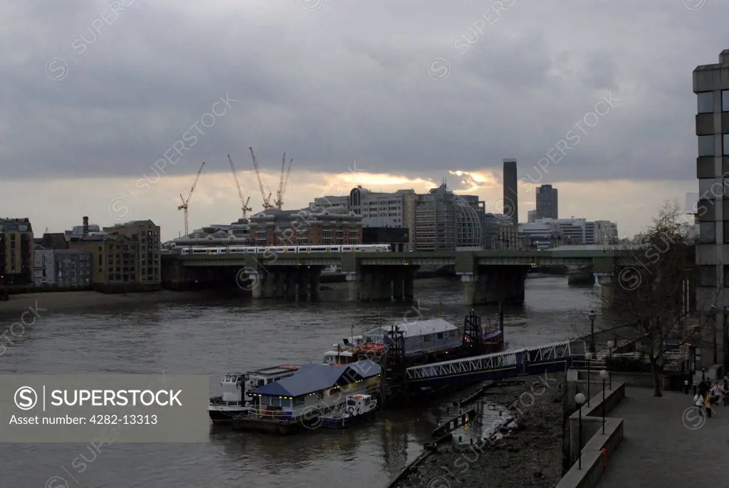 England, London, City of London. View from London Bridge at dusk.