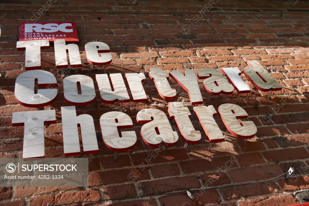 England, Warwickshire, Stratford-upon-Avon. The Courtyard Theatre signage on a wall outside the building.