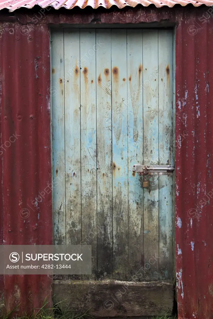 Scotland, Highland, Talisker. A decaying barn door near Talisker on the Isle of Skye.