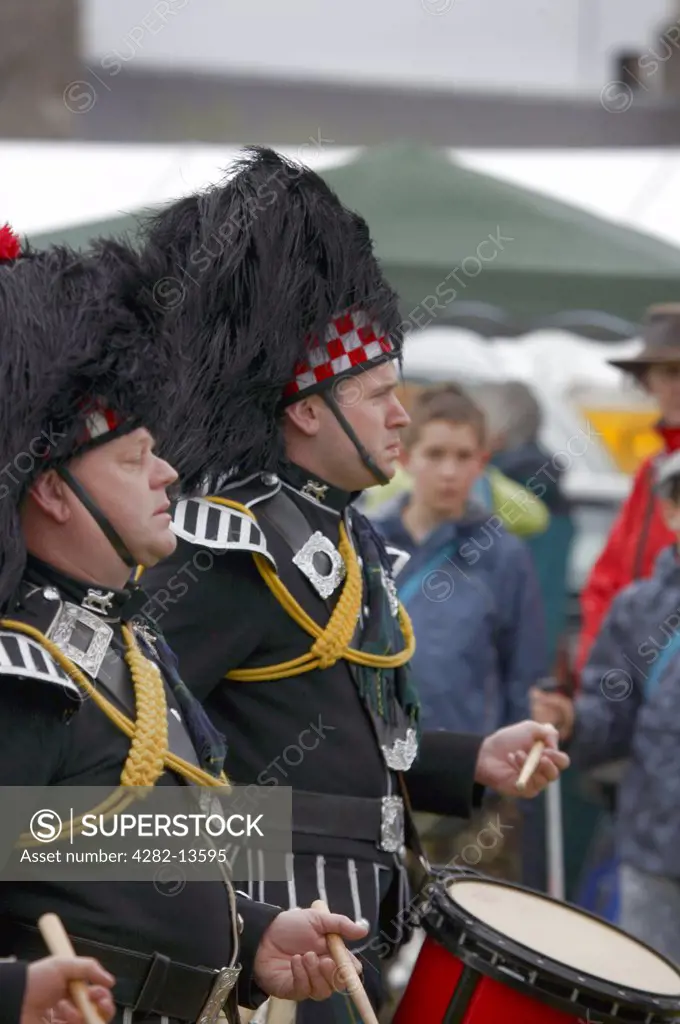 Scotland, Aberdeenshire, Strathdon. Drummers from The Ballater and District Pipe Band performing at the Lonach Gathering and Highland Games, (billed as Äö?Ñ??Scotland's friendliest Highland GamesÄö?Ñ?¥) held annually in August.