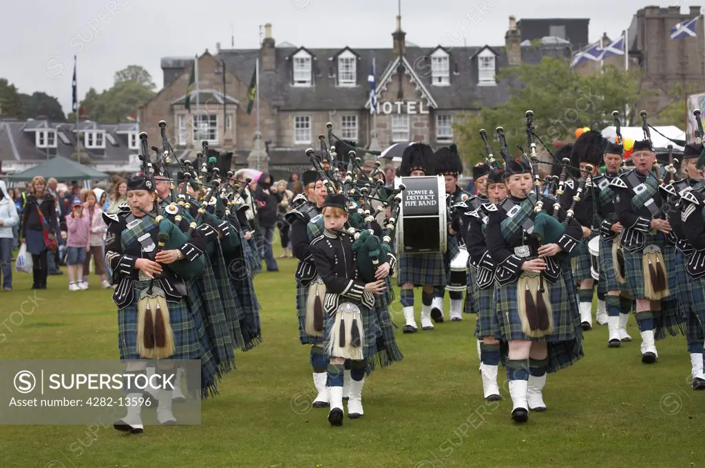 Scotland, Aberdeenshire, Strathdon. The Towie and District Pipe Band marching at the Lonach Gathering and Highland Games, (billed as Äö?Ñ??Scotland's friendliest Highland GamesÄö?Ñ?¥) held annually in August.