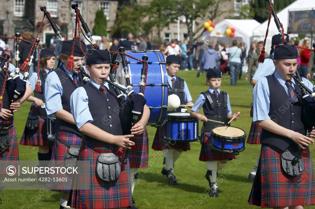 Scotland, Aberdeenshire, Strathdon. A youth pipe band marching at the Lonach Gathering and Highland Games, (billed as Äö?Ñ??Scotland's friendliest Highland GamesÄö?Ñ?¥) held annually in August.