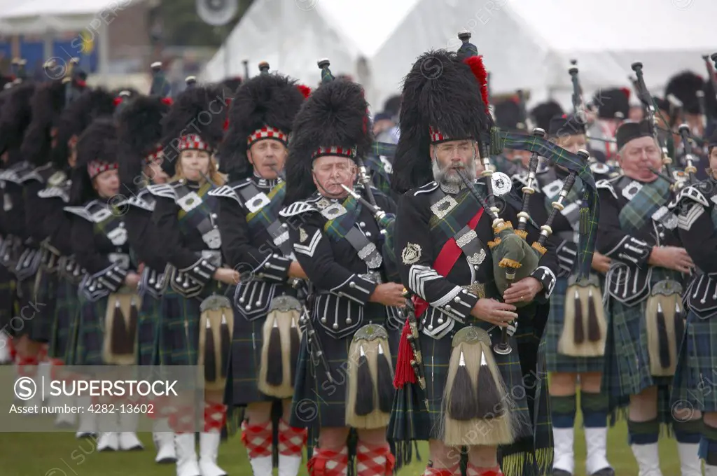 Scotland, Aberdeenshire, Strathdon. A pipe band performing at the Lonach Gathering and Highland Games, (billed as ’Scotland’s friendliest Highland Games’) held annually in August.