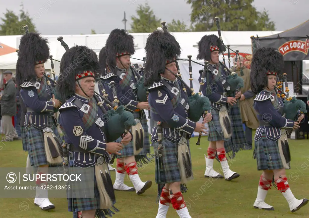 Scotland, Aberdeenshire, Strathdon. A marching pipe band performing at the Lonach Gathering and Highland Games, (billed as Äö?Ñ??Scotland's friendliest Highland GamesÄö?Ñ?¥) held annually in August.