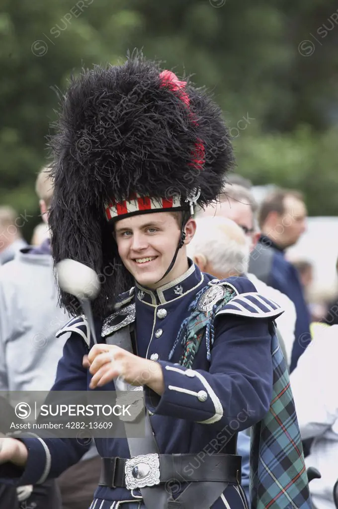 Scotland, Aberdeenshire, Strathdon. A drummer from a pipe band marching at the Lonach Gathering and Highland Games, (billed as Äö?Ñ??Scotland's friendliest Highland GamesÄö?Ñ?¥) held annually in August.