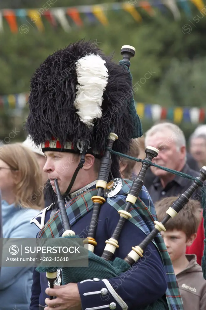 Scotland, Aberdeenshire, Strathdon. A piper at the Lonach Gathering and Highland Games, (billed as Äö?Ñ??Scotland's friendliest Highland GamesÄö?Ñ?¥) held annually in August.