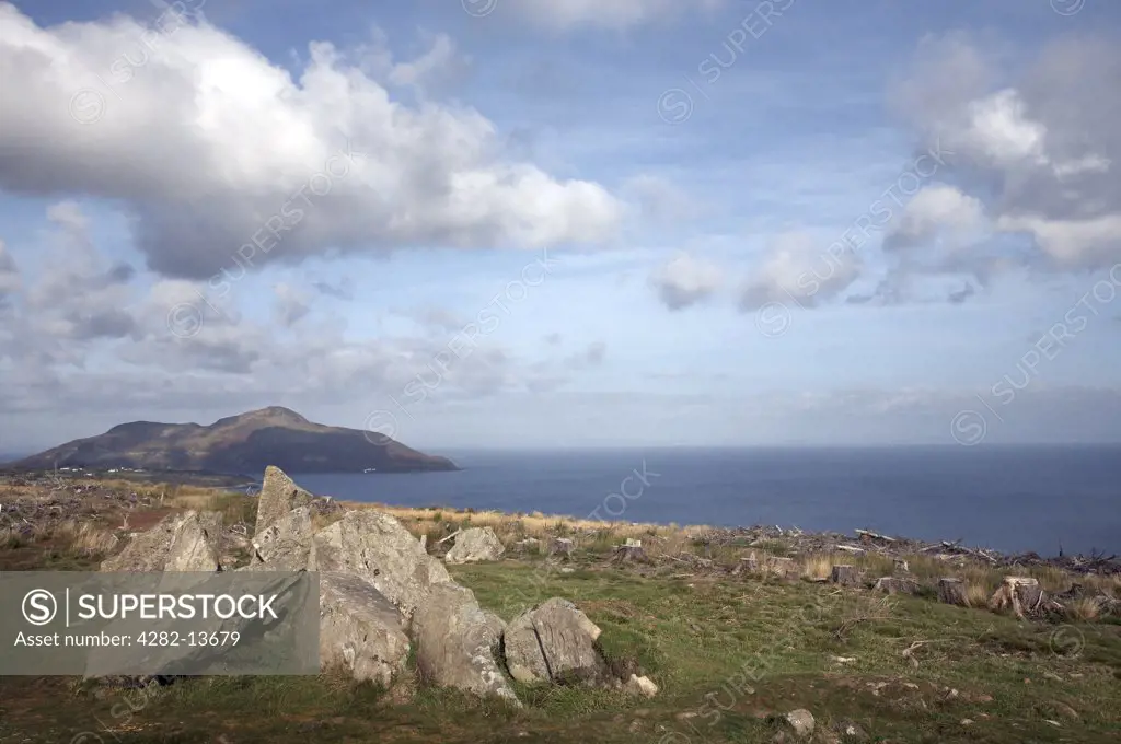 Scotland, North Ayrshire, Glenashdale. Giants Grave, chambered cairns from the Neolithic period in Glenashdale on the Isle of Arran. Holy Island in Lamlash Bay can be seen in the distance.