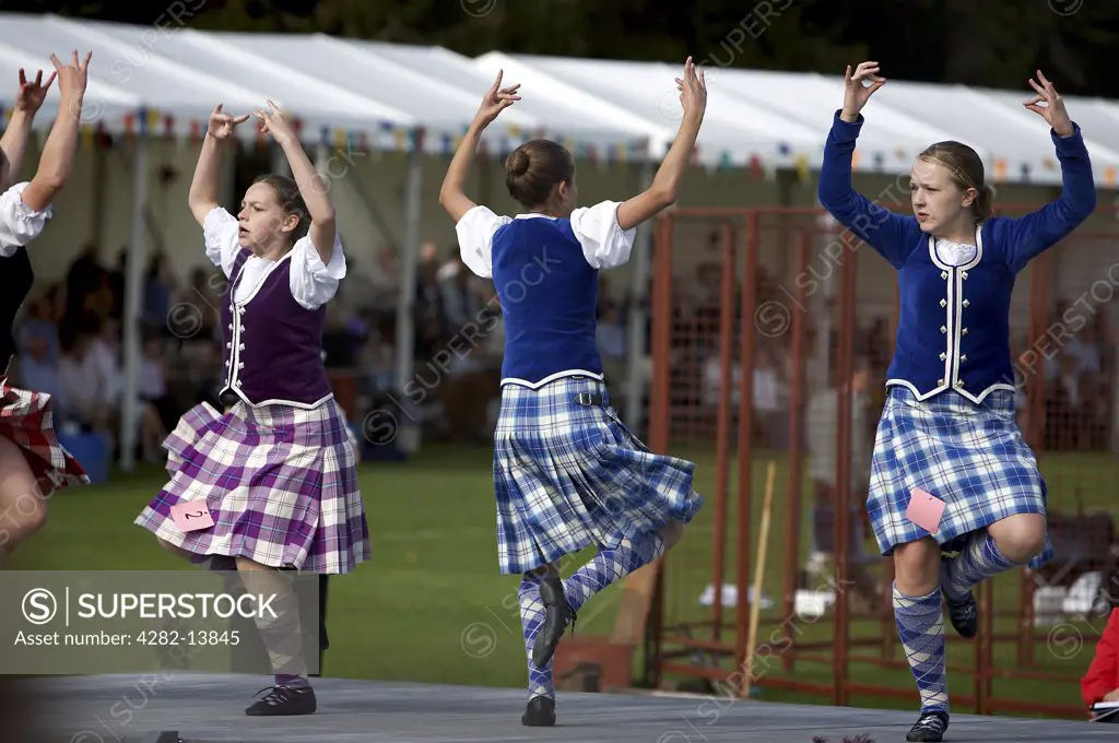 Scotland, Aberdeenshire, Strathdon. Highland dance girls in competition at the Lonach Highland Games.
