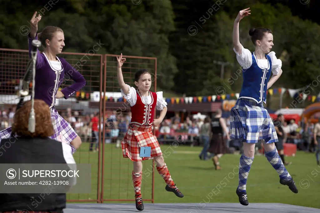 Scotland, Aberdeenshire, Strathdon. Young female highland dancers performing at the Lonach Highland Games.