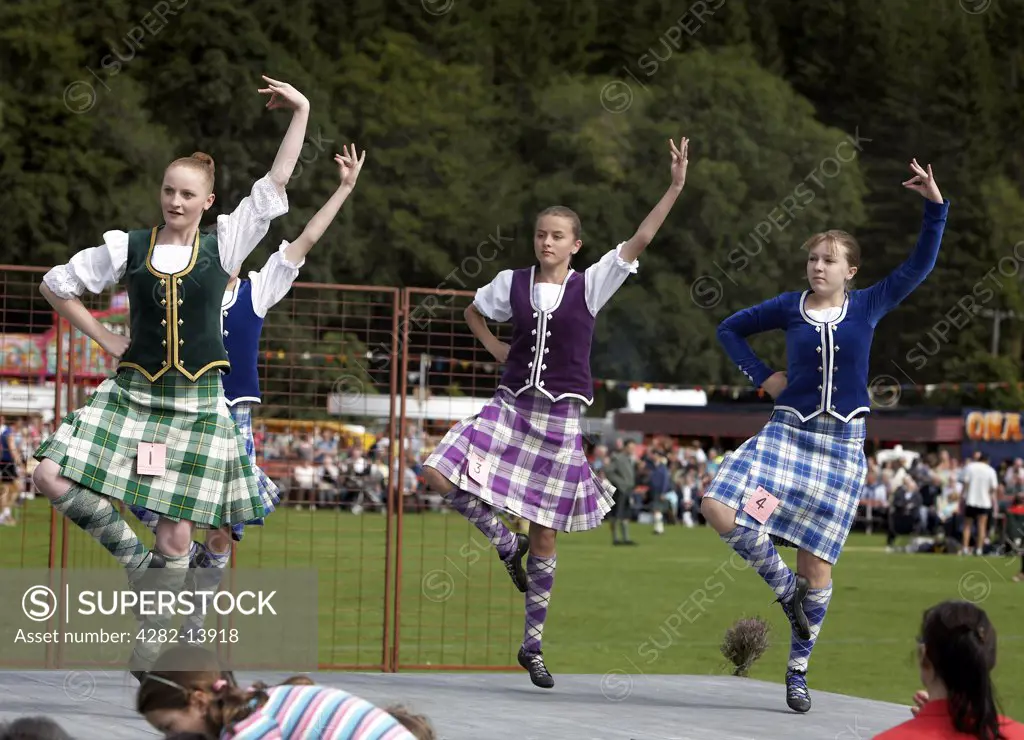 Scotland, Aberdeenshire, Strathdon. Young female highland dancers performing at the Lonach Highland Games.