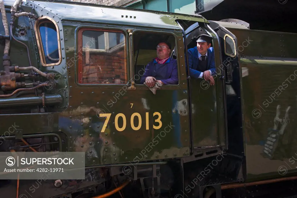 England, Leicestershire, Rothley. Two engine drivers wait for the signals to change at Rothley Station, Britain's only double track main line heritage railway.