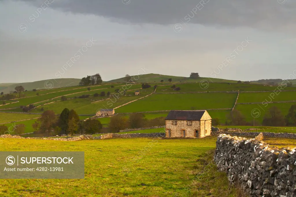 England, Derbyshire, Hartington. Stone barns in a rural Derbyshire landscape.