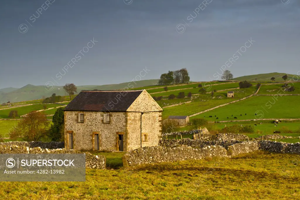 England, Derbyshire, Hartington. Stone barns in a rural Derbyshire landscape.