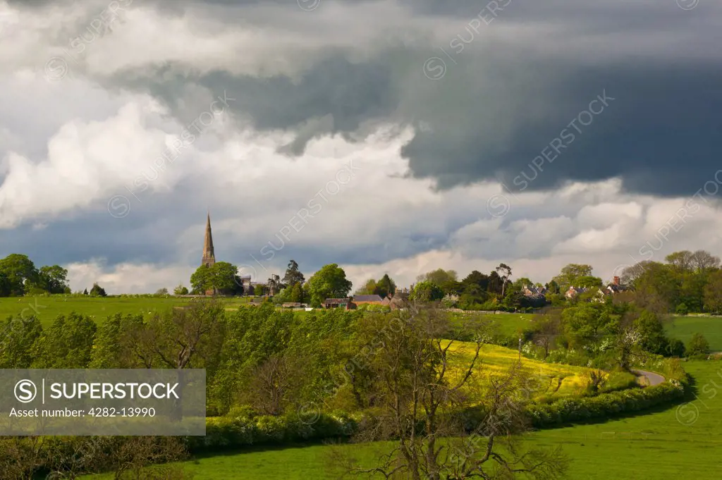 England, Northamptonshire, Brampton Ash. Storm clouds gather over the rural village of Brampton Ash.