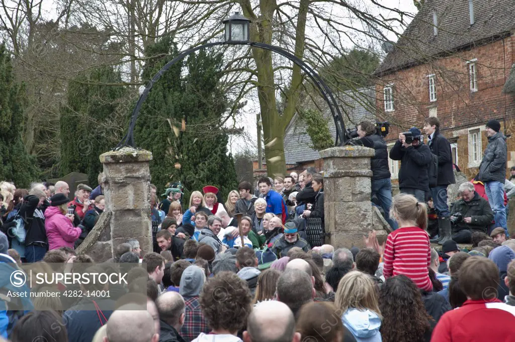 England, Leicestershire, Hallaton. A hare pie is thrown to the crowd for the traditional scramble on Easter Monday.