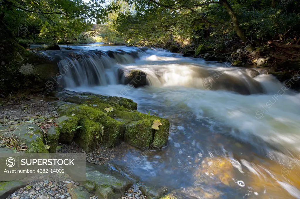 England, Cumbria, Caldbeck. The River Caldew flowing over rocks through Caldbeck.