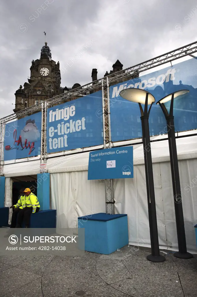 Scotland, Midlothian, Edinburgh. Fringe Festival e-ticket tent and the top of the Balmoral Hotel in Princes Street in the New Town of Edinburgh.