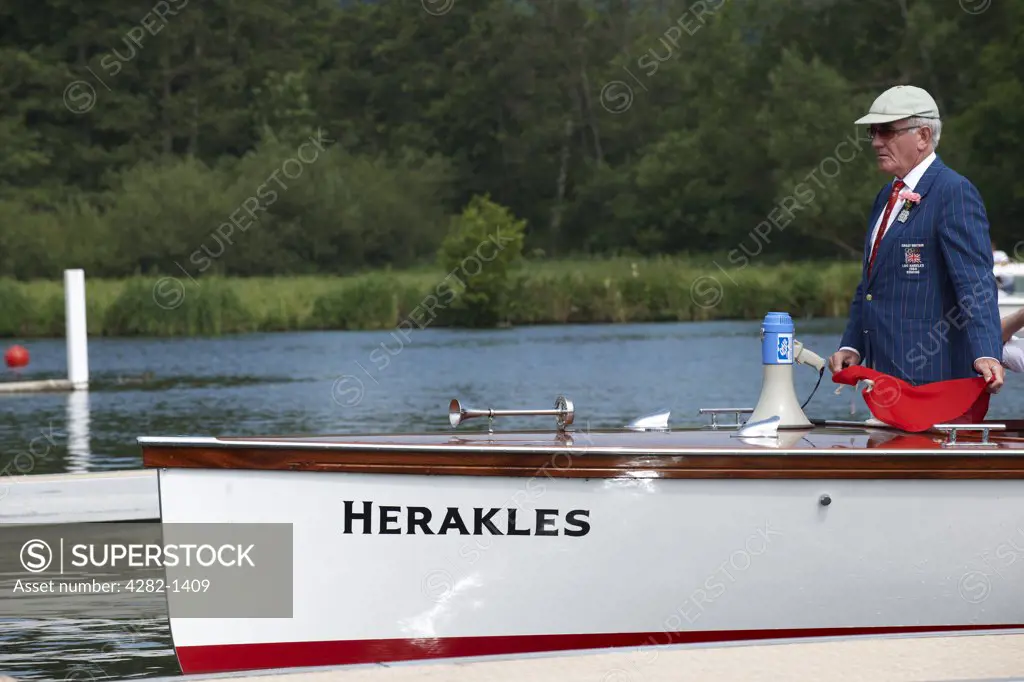 England, Oxfordshire, Henley-on-Thames. An umpire preparing to start a race at the annual Henley Royal Regatta.