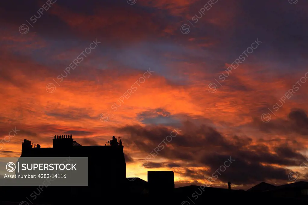 Scotland, City of Edinburgh, Edinburgh. A silhouette of a building against a red sky sunset in Edinburgh.