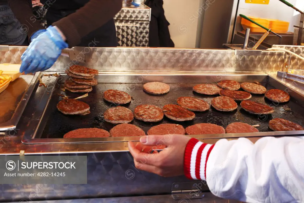 England, Merseyside, Liverpool. Burgers and fries being prepared in a van on Anfield Road on a match day in Liverpool.