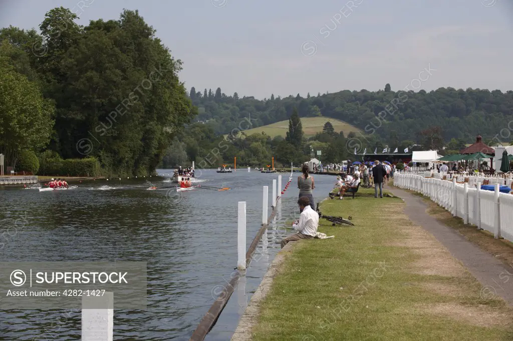 England, Oxfordshire, Henley-on-Thames. Two boat crews rowing past Temple Island at the annual Henley Royal Regatta.