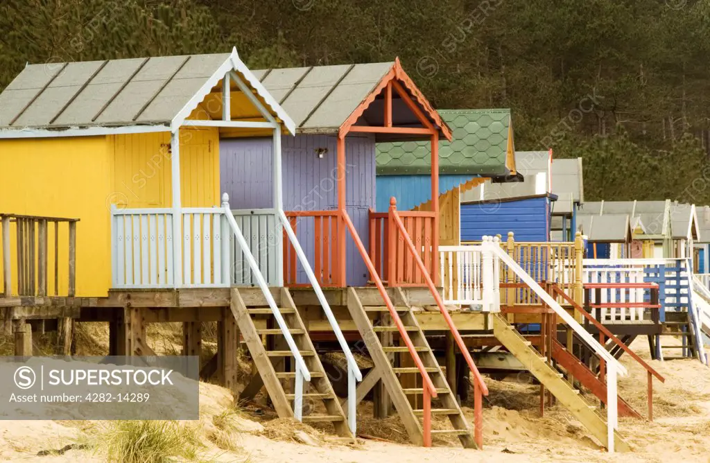 England, Norfolk, Wells-Next-The-Sea. A view of beach huts at Wells-Next-The-Sea. This area is part of the Holkham Estate and there are vast unspoiled beaches and woodland areas.