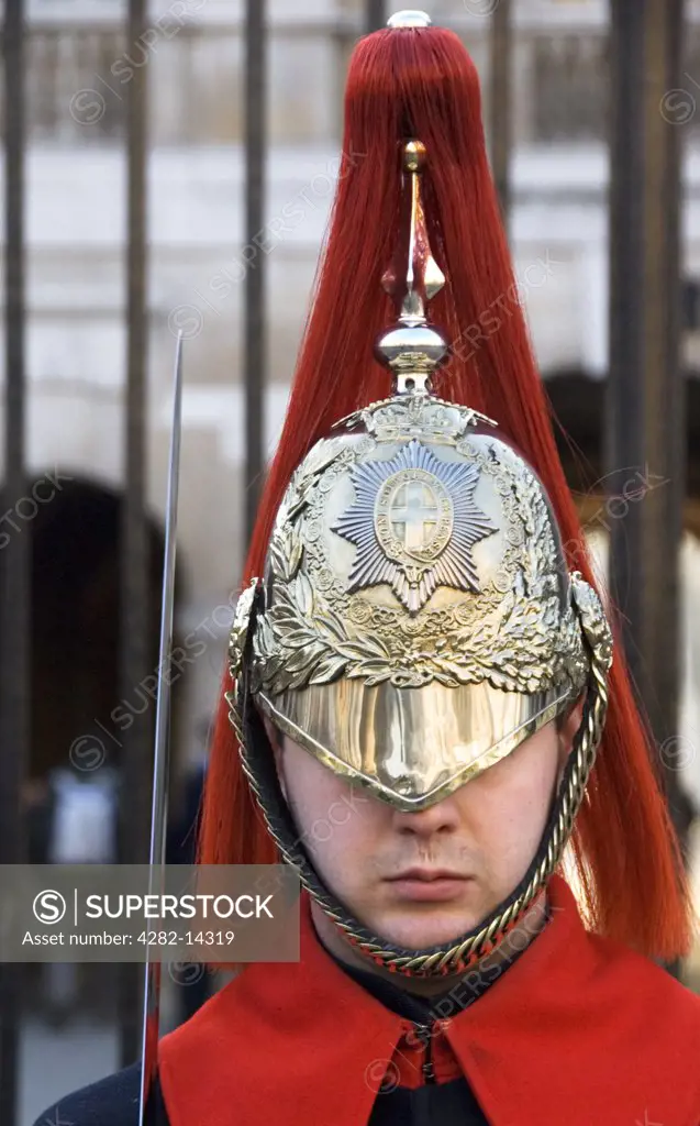 England, London, Buckingham Palace. Detail of Household Cavalry guard's helmet and sword. The Household Cavalry  provides the Queen's Life Guard daily and Sovereign's Escort on state occasions.