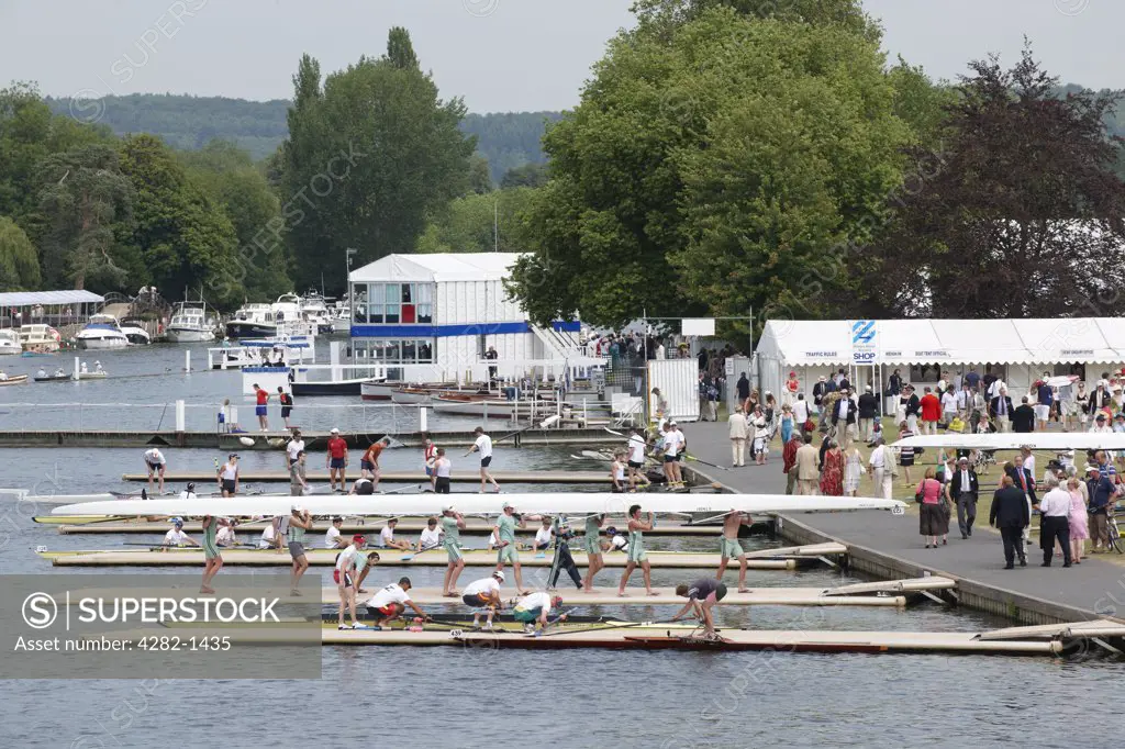 England, Oxfordshire, Henley-on-Thames. Boat crews preparing to race at the annual Henley Royal Regatta.