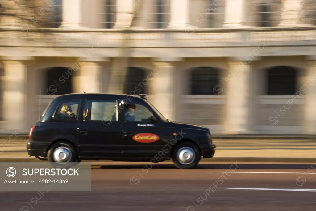 England, London, Victoria. A traditional black taxi on a London street.