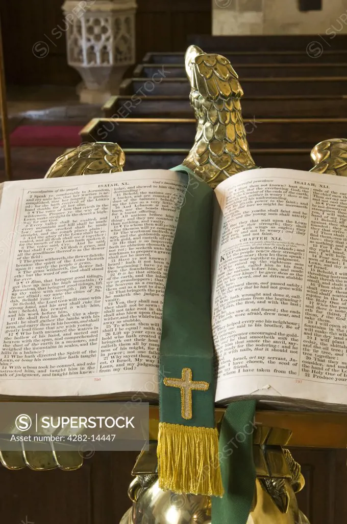 England, Gloucestershire, Upper Slaughter. Open bible in front of the pews in St Peter's Church.