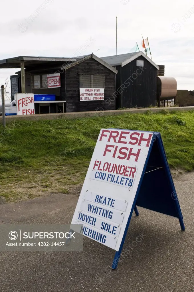 England, Suffolk, Aldeburgh. Signs outside a fish sellers stall on the seafront at Aldeburgh.