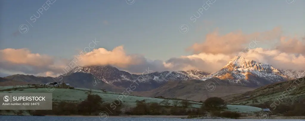 Wales, Clwyd, Capel Curig. A view of pink clouds surrounding the peak of Mount Snowdon from Capel Curig.