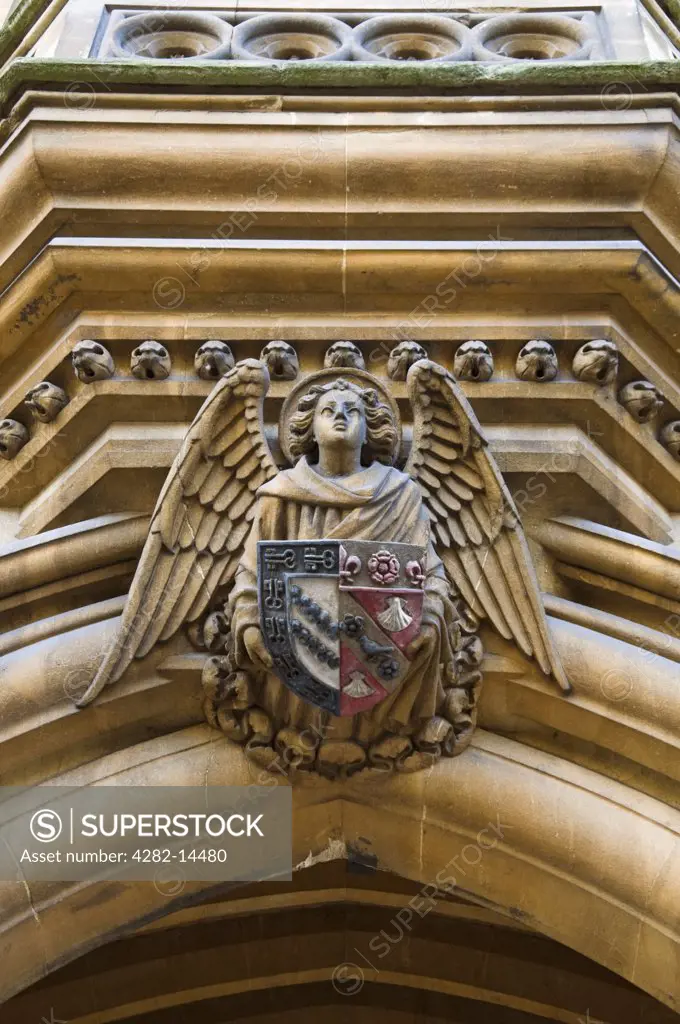 England, Oxfordshire, Oxford. Ornate detail on the coat of arms on the door leading to Exeter College in Oxford.