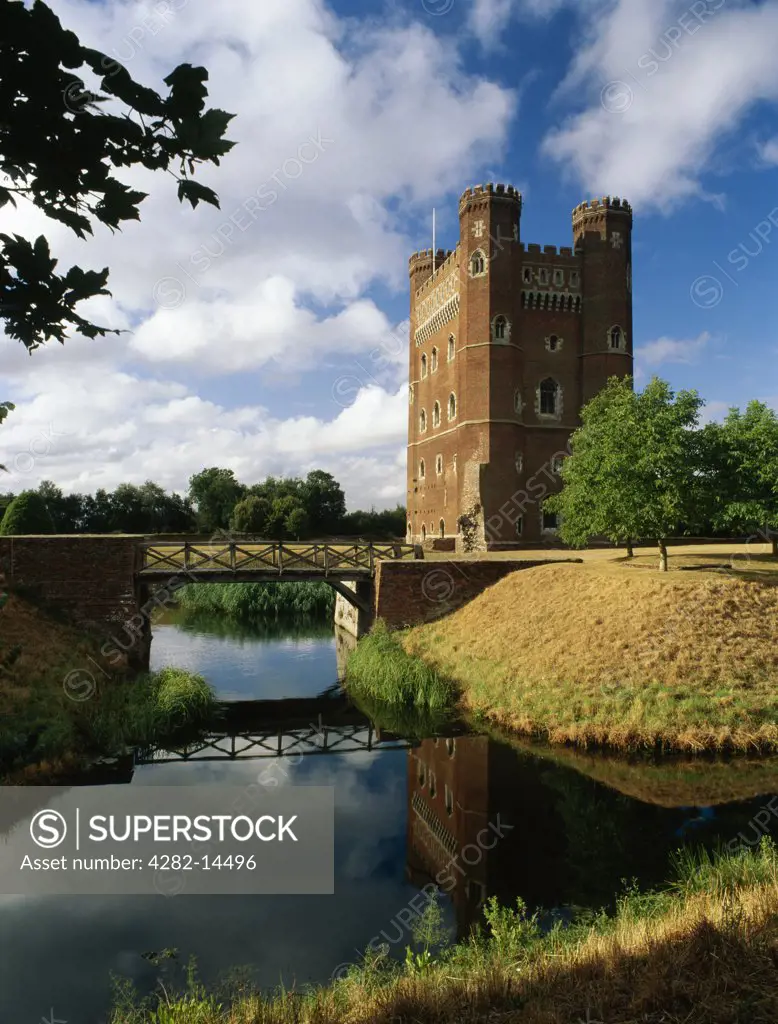 England, Lincolnshire, Tattershall. A view across the moat to the mid 15th century rectangular tower keep of Tattershall Castle, noted for its early use of brick.