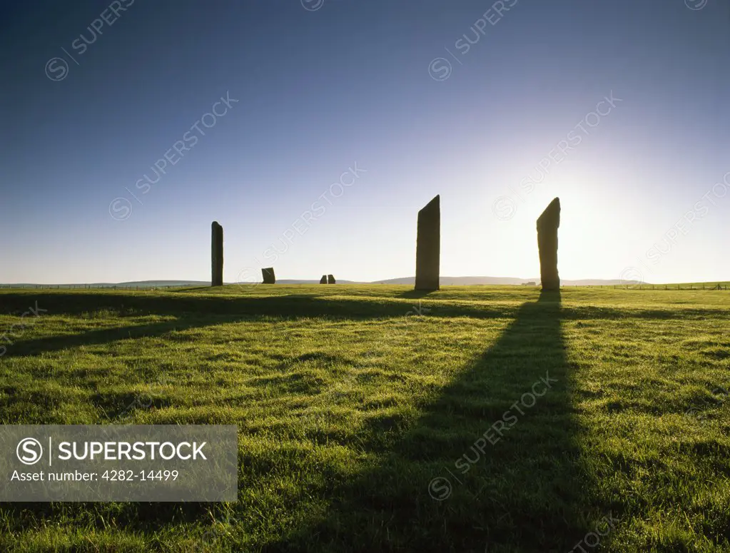Scotland, Orkney, Stones of Stenness. Stones of Stenness stone circle and henge silhouetted at sunrise.