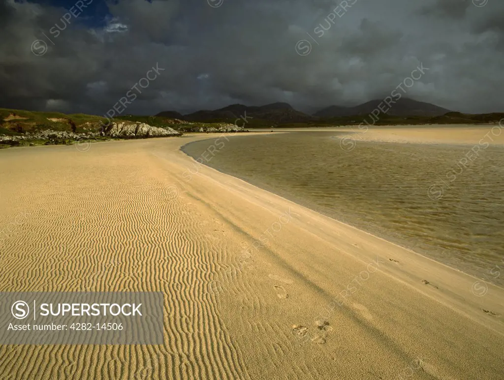 Scotland, Isle of Lewis, Uig Sands. Looking southwards at the Lon Erista river flowing out across Traigh Uige (Uuige) on the Valtos (Bhaltos) peninsula. The Lewis Viking Chessmen were uncovered in the dunes to the rear, beyond which are the mountains of Mealisval and Tahaval.