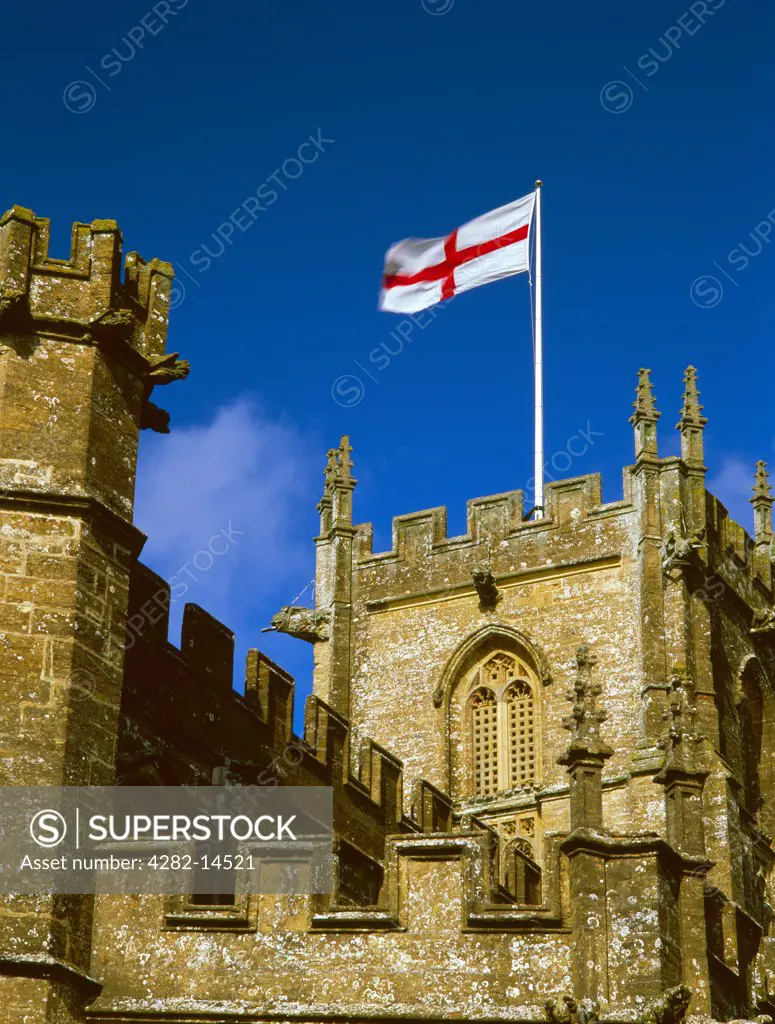 England, Somerset, Crewkerne. The flag of St George flying from the tower of St Bartholomew's late Medieval church which was originally founded as a Saxon minster.