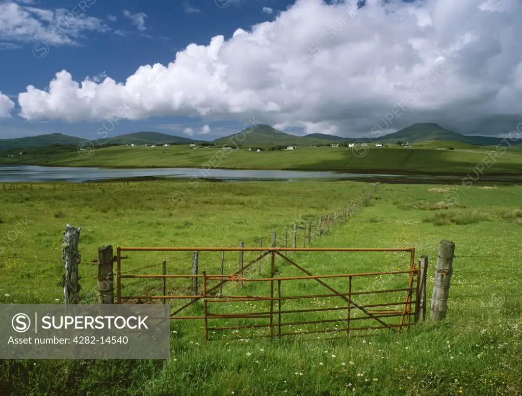 Scotland, Isle of Skye, Macleod's Tables. Looking SW from near Vatten, across Pool Roag and Roag crofting village to two distinctive flat-topped and stepped hills of basaltic lava associated with Alasdair Crotach, 7th chief of the MacLeods of Dunvegan.