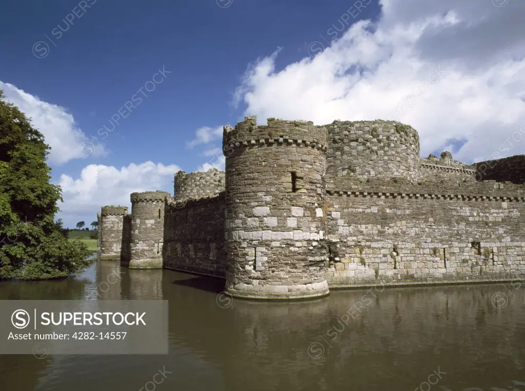 Wales, Anglesey, Beaumaris. Looking across the moat at the SW tower and outer curtain wall of Edward I's Beaumaris Castle.