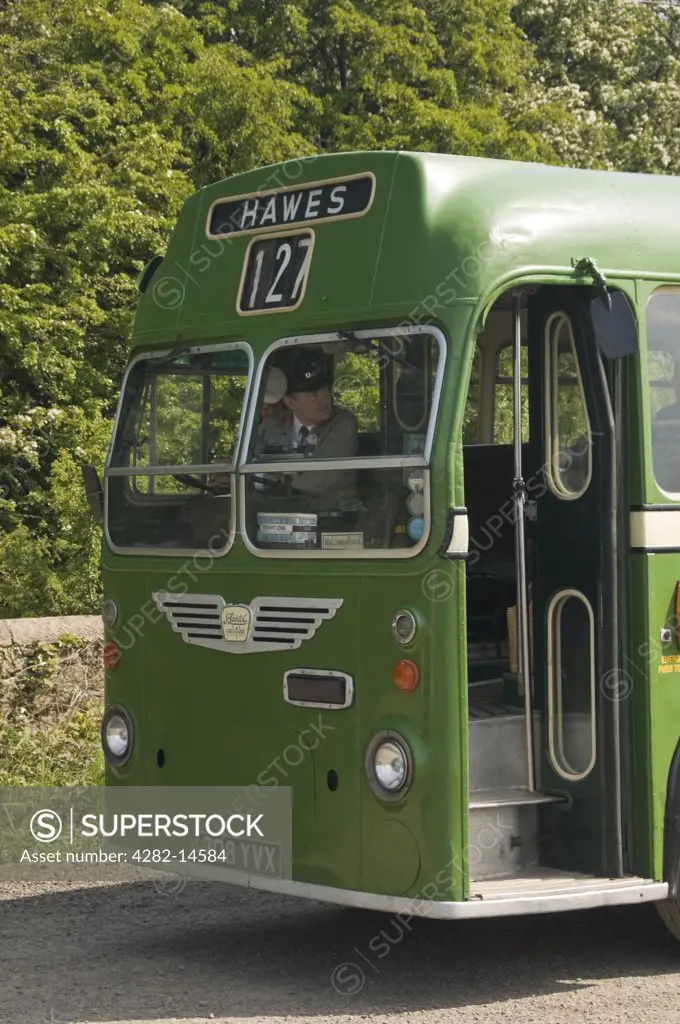 England, North Yorkshire, Leeming Bar. A classic old green bus waiting for passengers outside Leeming Bar station on the Wensleydale Railway, near Bedale.