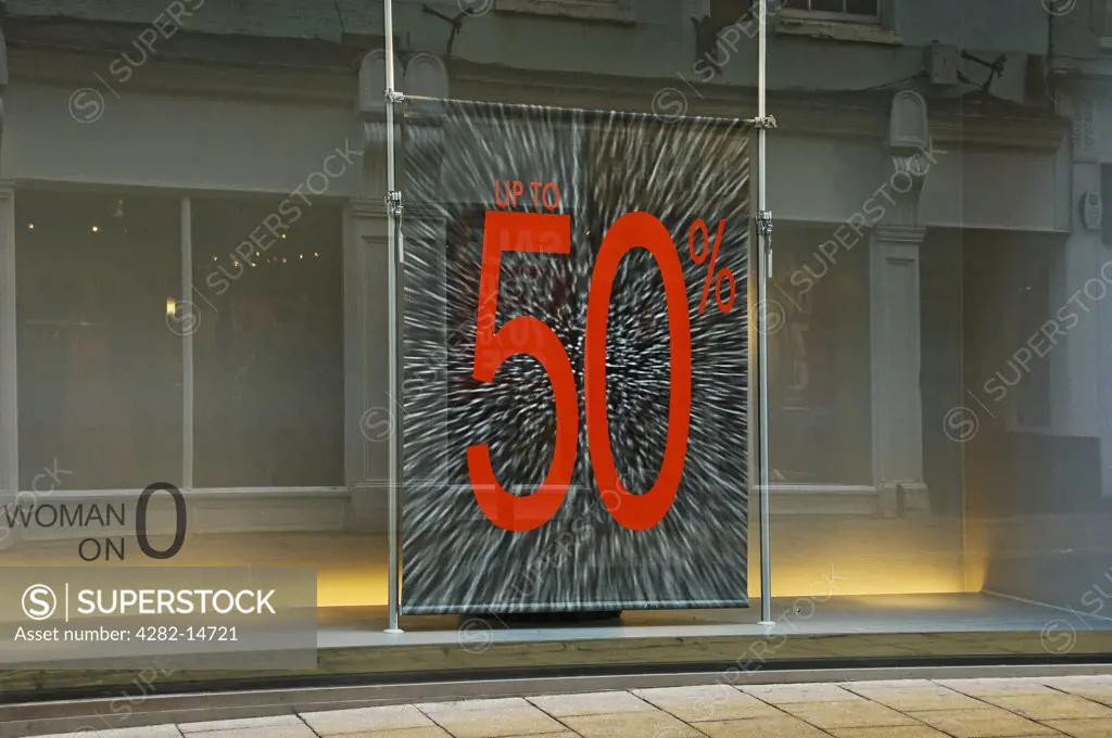 England, North Yorkshire, York. A large 'up to 50%' sale sign in a shop window.